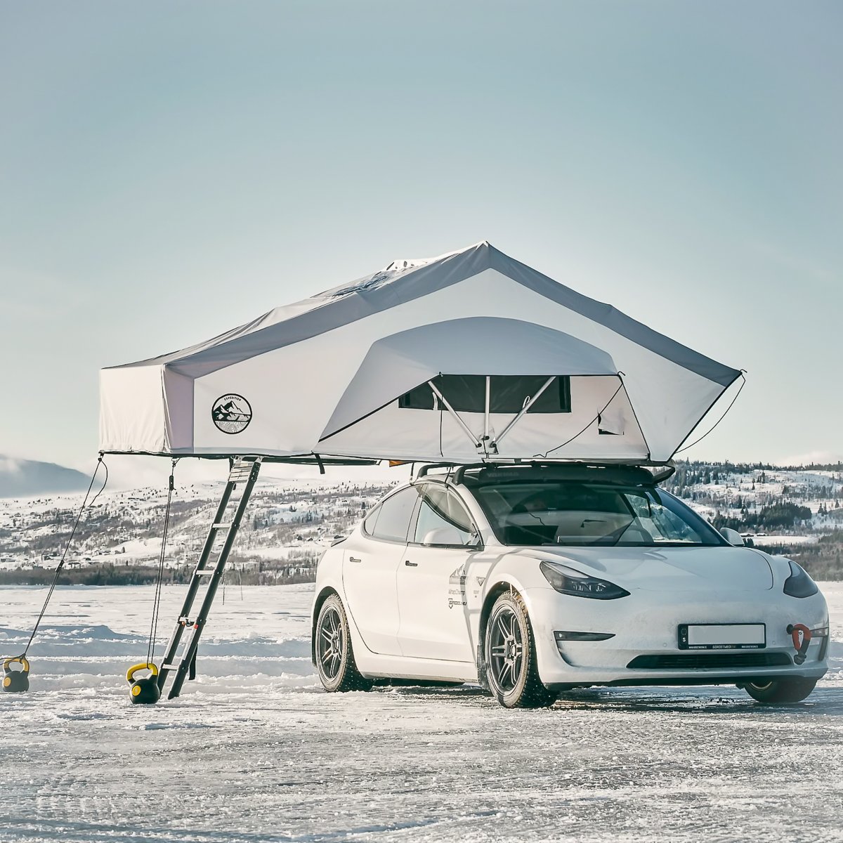 Delta Freecamp Uranus roof top tent mounted on a Tesla for outdoor camping