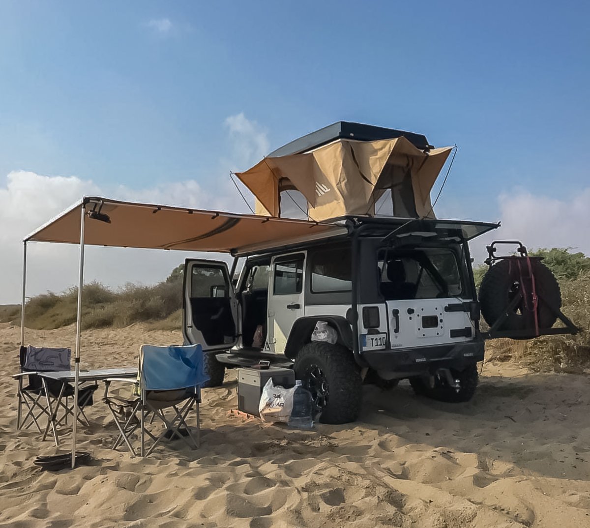 Vehicle side awning mounted on 4x4 SUV for outdoor camping